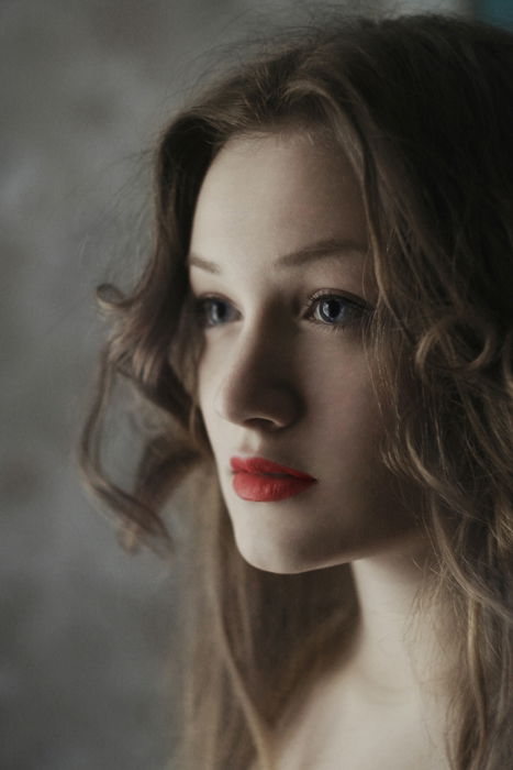 A close-up profile of a beautiful woman using a 1 light setup for portraits