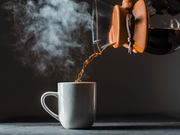 Pouring a cup of steaming coffee 