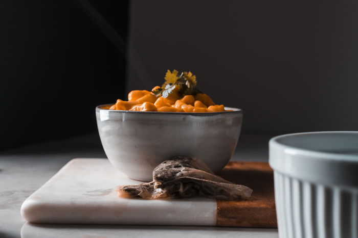 Teabags behind a bowl of mac and cheese.