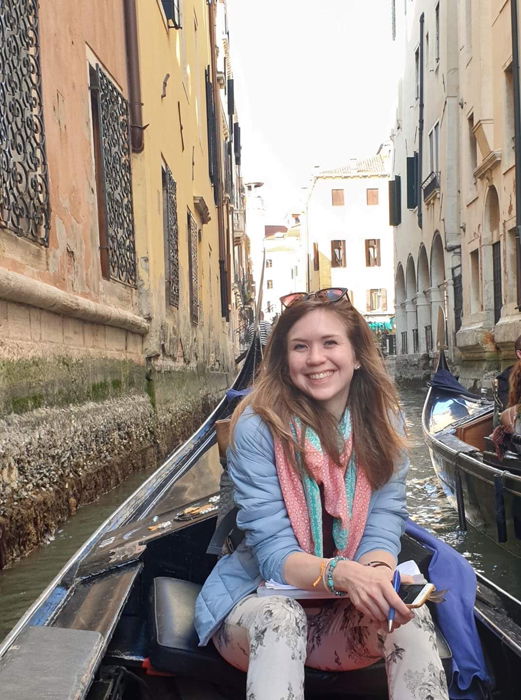 A smiling girl on a gondola in Venice