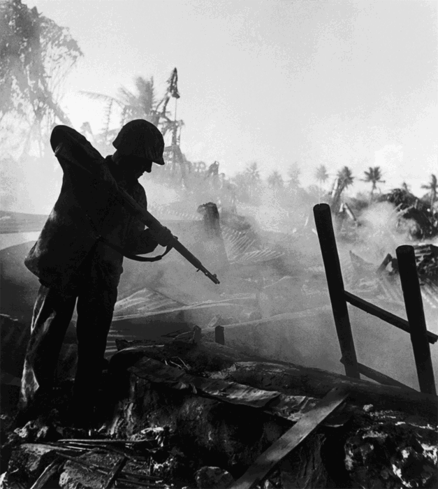 A soldier aiming at the ground.