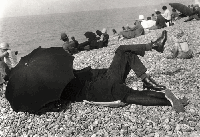 Henri Cartier-Bresson image of a man and woman under an umbrella on a beach