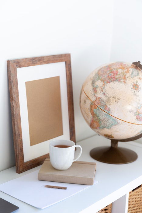 photo frame and globe on desk