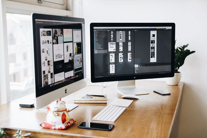 Two monitors on an office desk