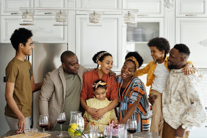 A large family posing in a kitchen