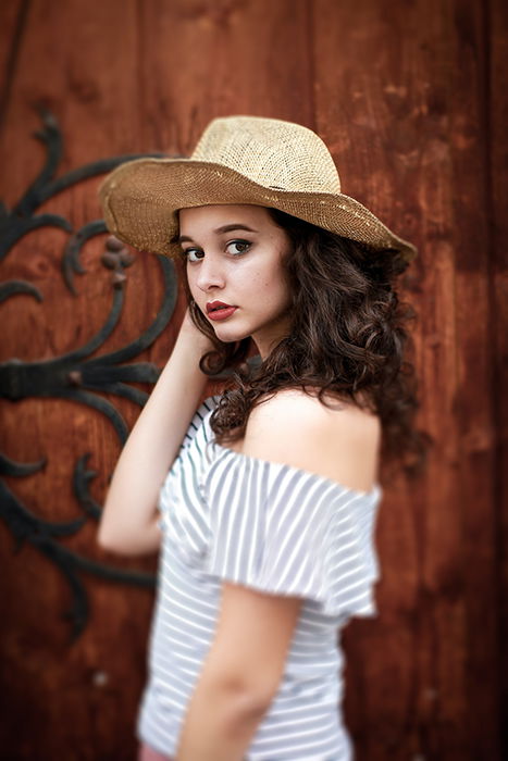 medium length portrait of a woman using a tilt shift lens