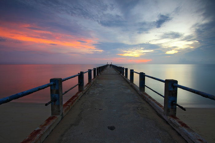 A small pier at sunset demonstrating vanishing points in photography