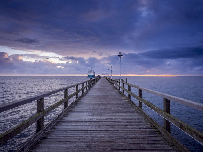 A wooden pier at sunset demonstrating vanishing points in photography