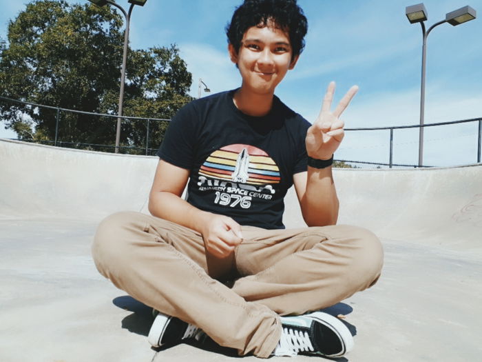 A man sitting crosslegged outdoors