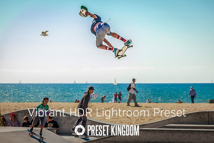 A skater in colorful socks, on the beach, jumping high in the air. 