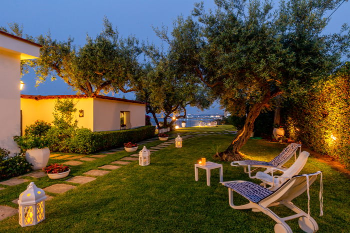 a real estate image of an exterior garden with lanterns spread throughout