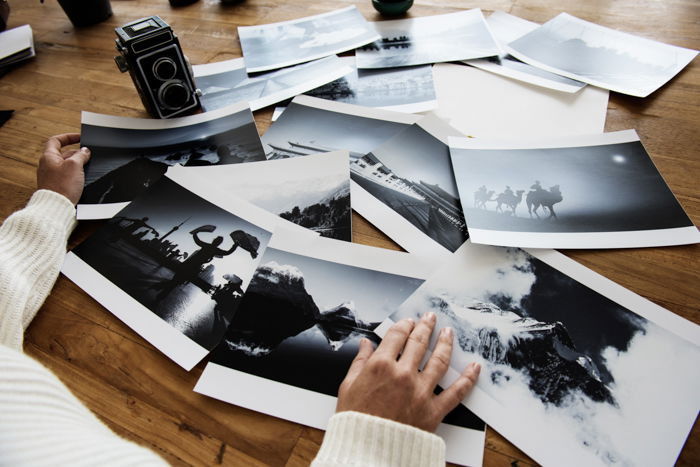 A person looking at printed photos