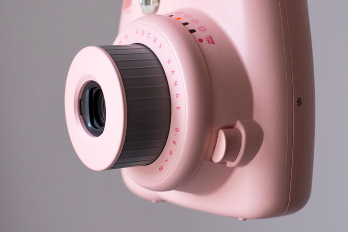 an image of the the lens from a pink fujifilm instax mini 8