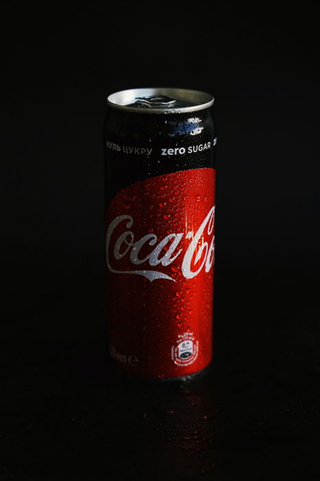 product photography photo of a CocaCola Coke can with a black studio background