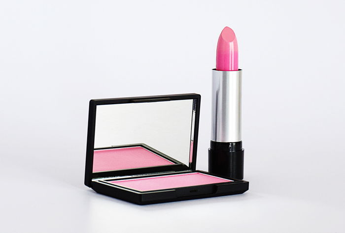 Product photography image of pink lipstick and blush, and case with a mirror