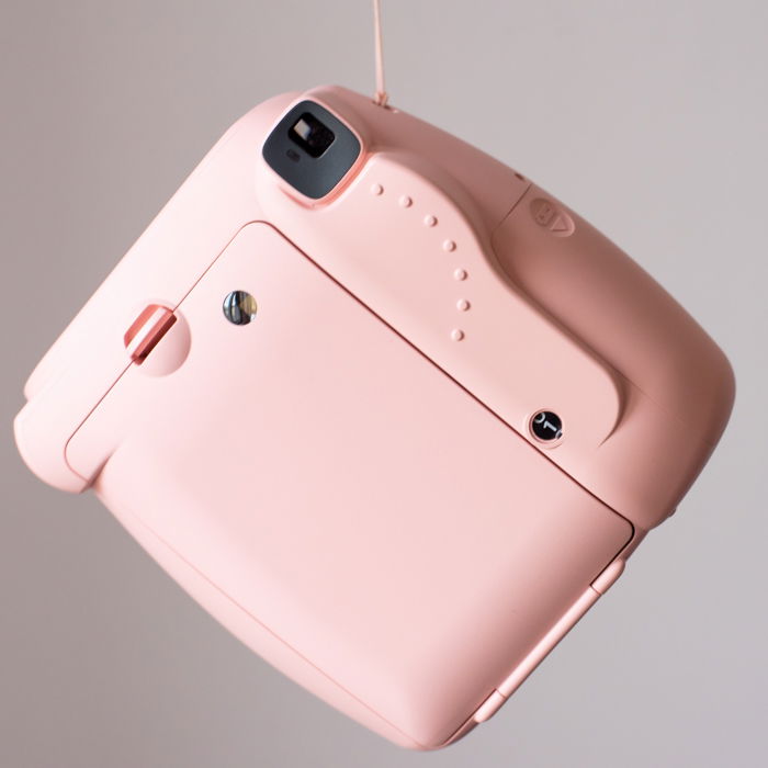 an image of the back of a pink fujifilmn instax mini 8 instant camera