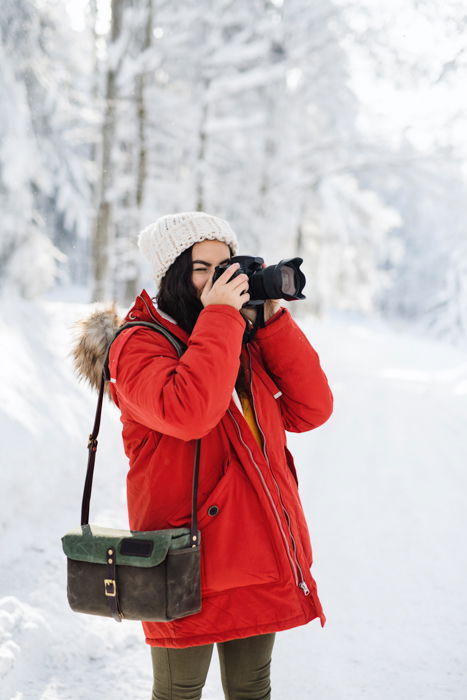 A photographer shooting winter photos outdoors