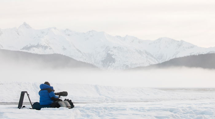 A photographer in a beautiful snow covered landscape