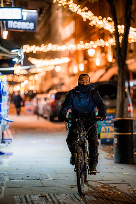 Street photography of a cyclist on the street taken with the Canon RF 85mm