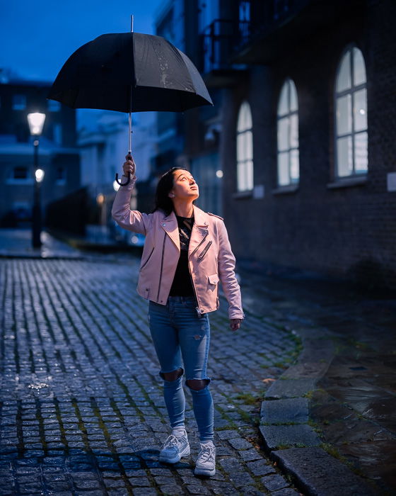 Portrait image of a girl with umbrella taken with the Canon RF 50mm f/1.2L USM lens at night