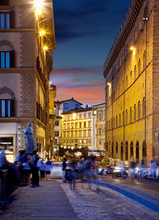 A busy street scene in low light