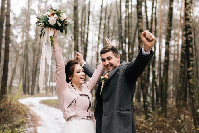 Happy couple posing in the woods