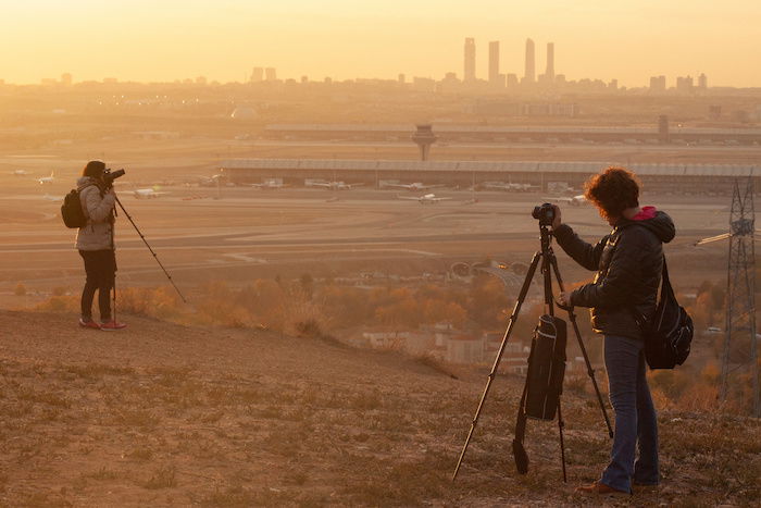 Two photographers on top of a hill.