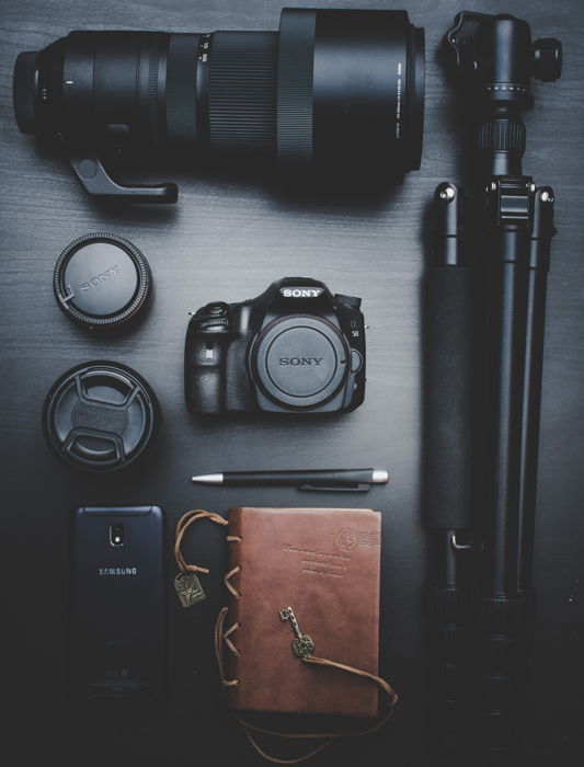 Various photography equipment and accessories on a black background.