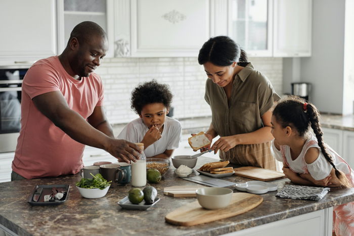 family of four around kitchen counter