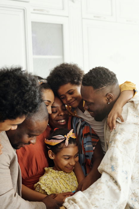 family picture of a group of of seven hugging each other