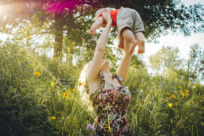 mother lifting baby family photo pose