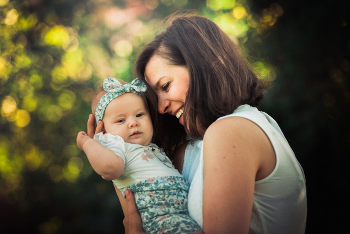 family photo poses mother with baby