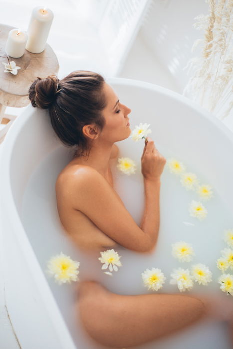 An intimate milk bath photography shoot with flowers