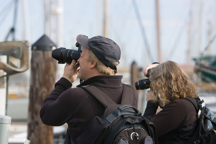 an image of a man and woman taking photographs