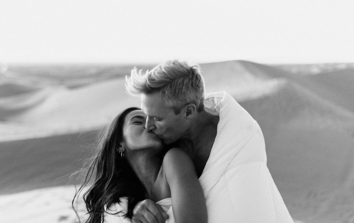 A couple kissing covered with a blanket as a Valentines day photoshoot idea