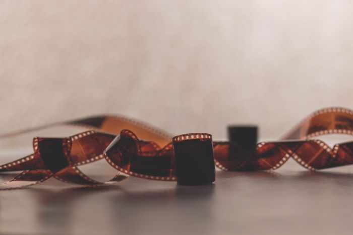 An image of a twisted roll of 35mm film negatives on a flat surface