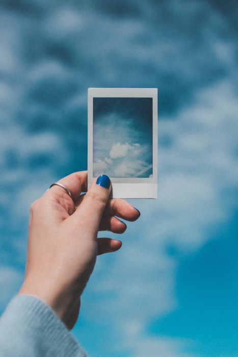 A hand holding a picture from an instant camera 