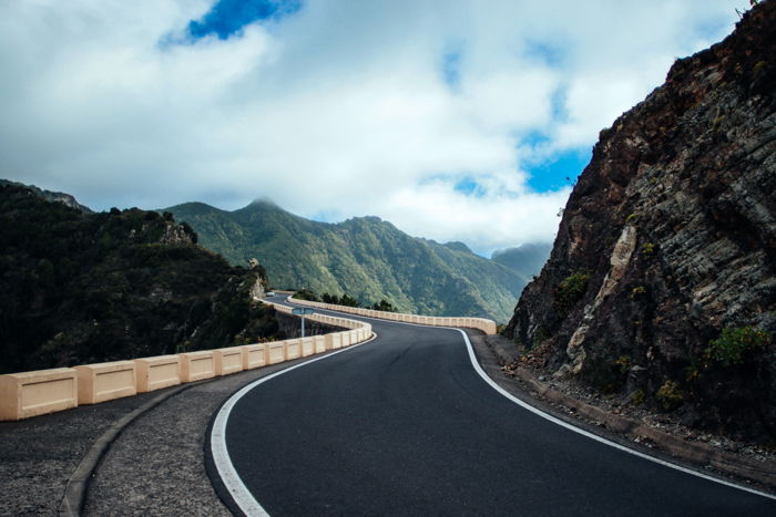 Image of a road cutting through the mountains to show how to use leading lines in photography