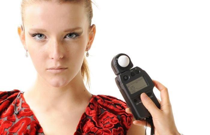 light metering a female model in a read dress