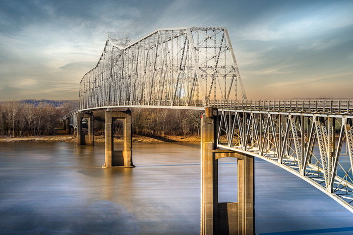 an image of a sky replacement above a bridge crossing a river