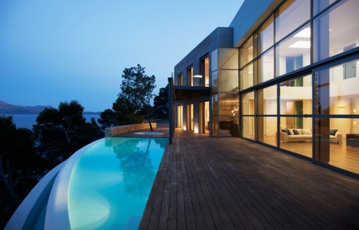 Pool outside modern house at twilight