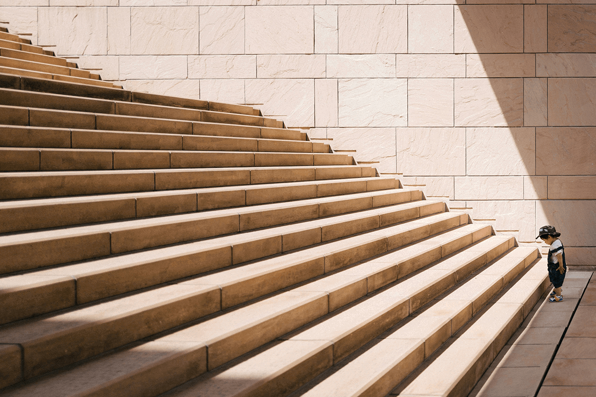 Boy standing at the bottom of stairs illustrating the visual weight of a narrative