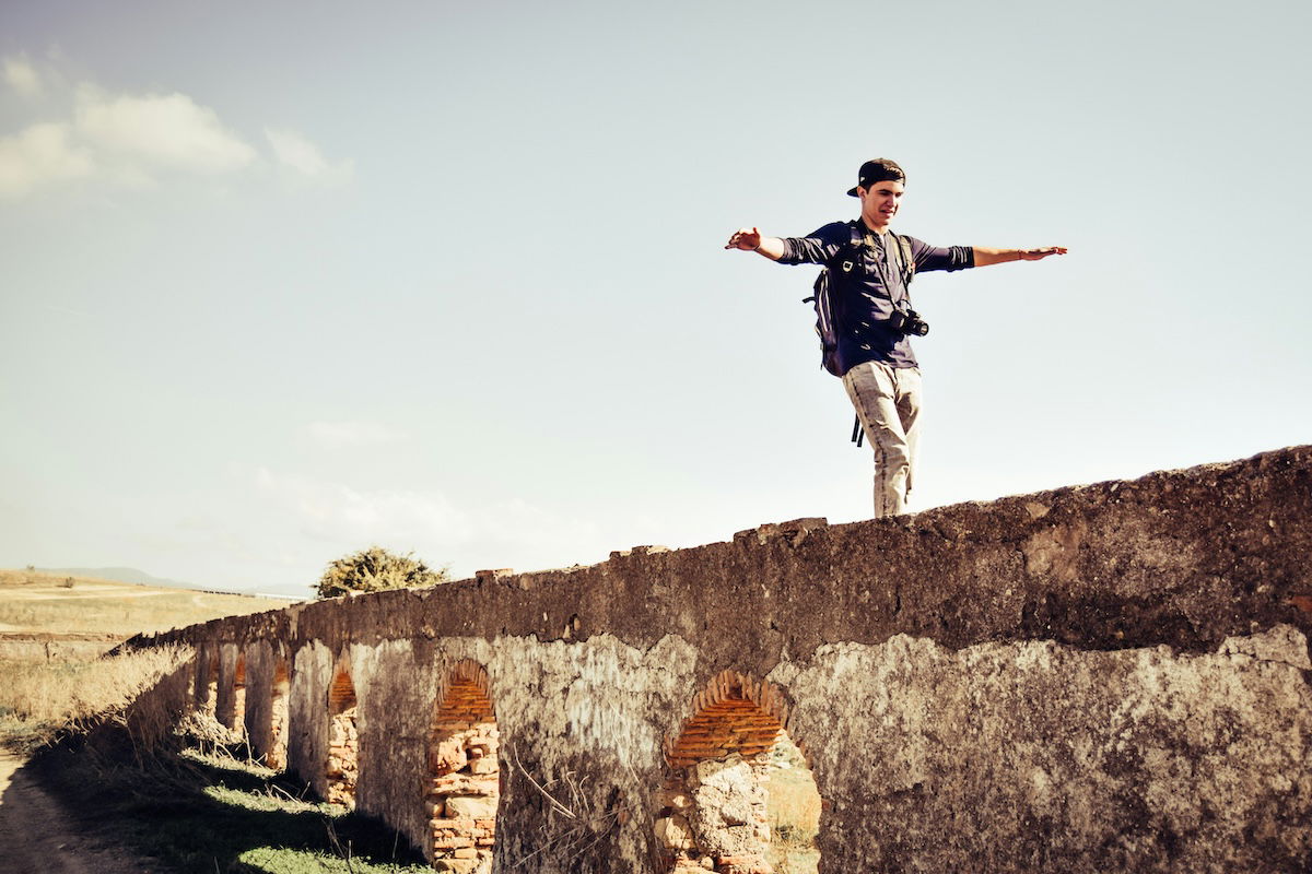 A photographer balancing on a bridge in a photo showing visual weight