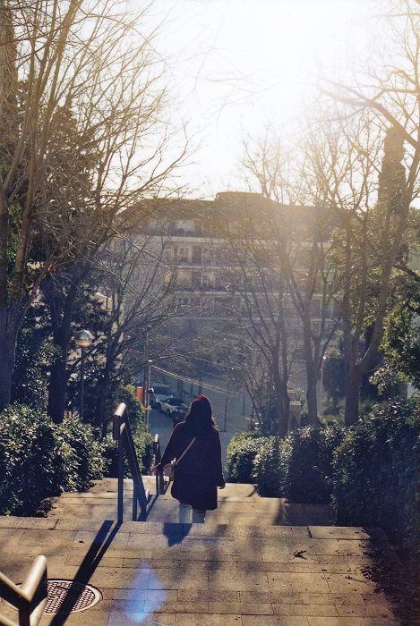 Golden hour photo of girl going down stairs outside