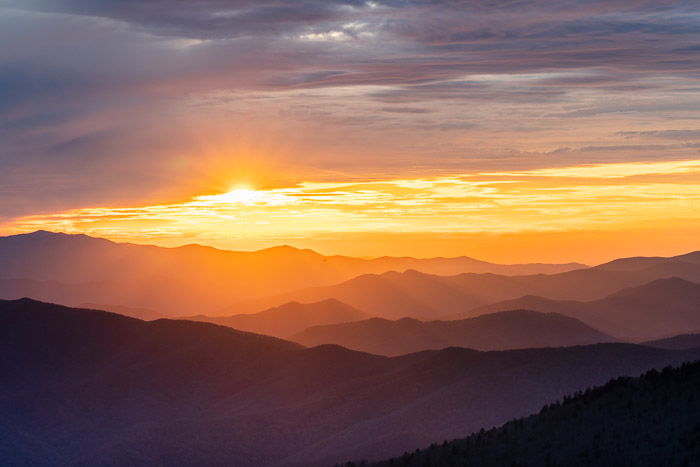 Sunrise image of mountain ranges to show best landscape photography settings for HDR