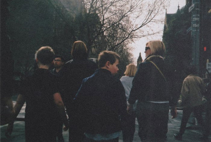 film grain on an image of a street with pedestrians