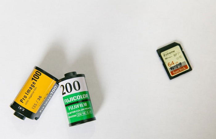 two film rolls compared to a SD card