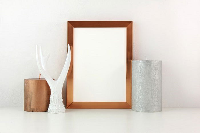 empty photo frame with candle decorations on either side