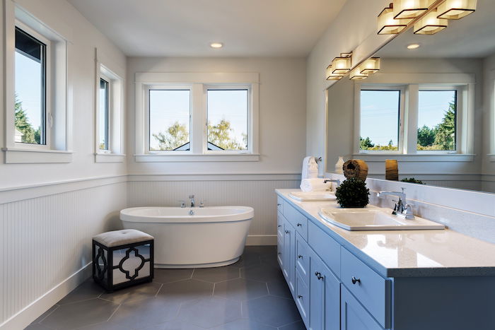 A bathroom with a bathtub and sinks shot for real estate photography