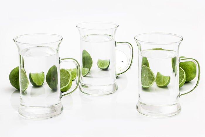 Limes refracted by glass pitchers of water demonstrating diffraction in studio light